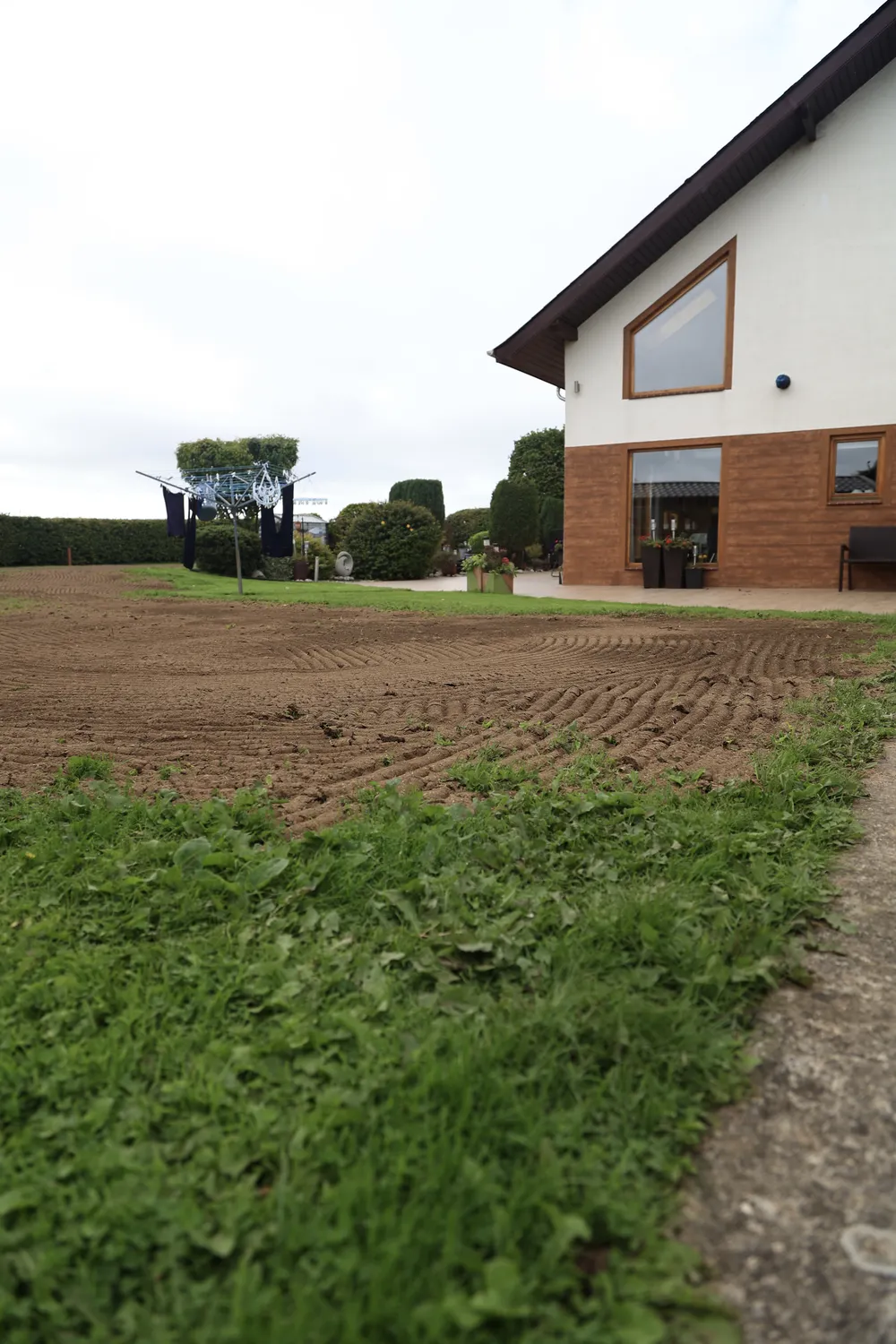 Garden ground newly levelled beside the wall of a house