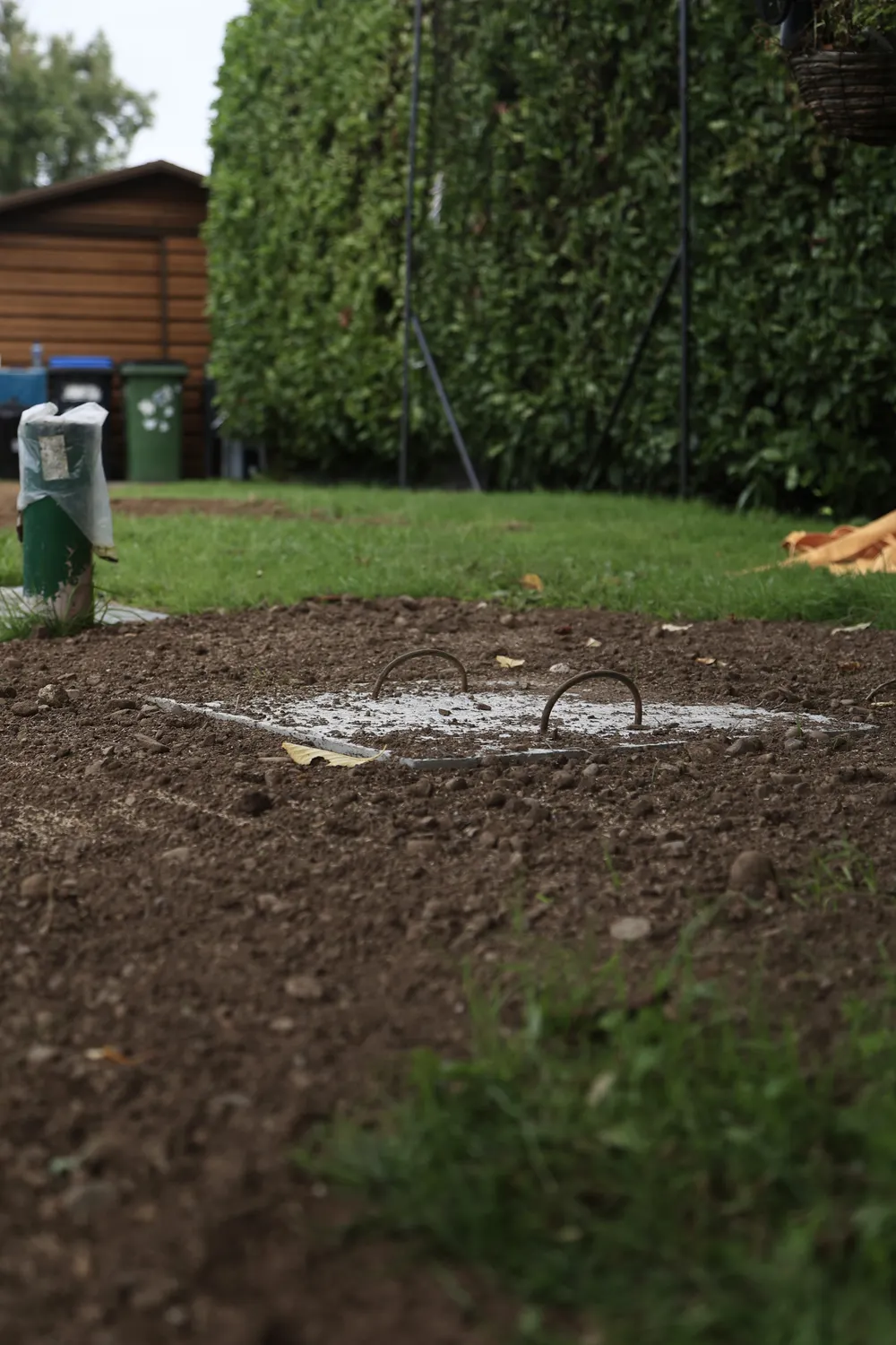 Freshly worked garden soil and patches of existing grass
