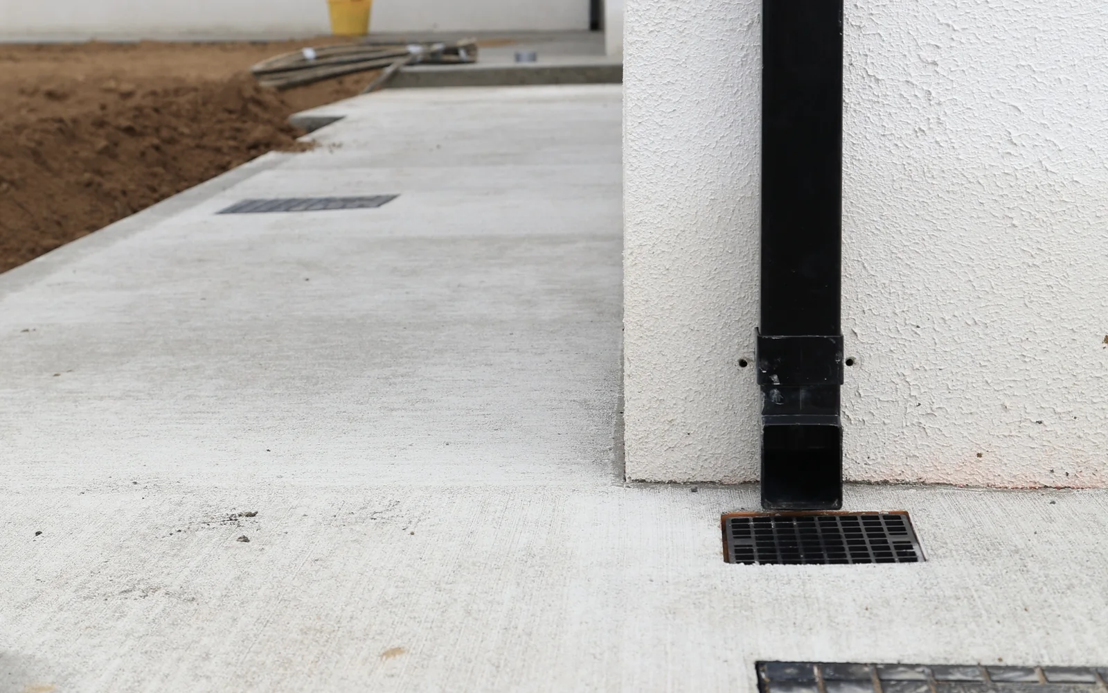 Finished concrete path and drainage channel along a new-build house in Carlow