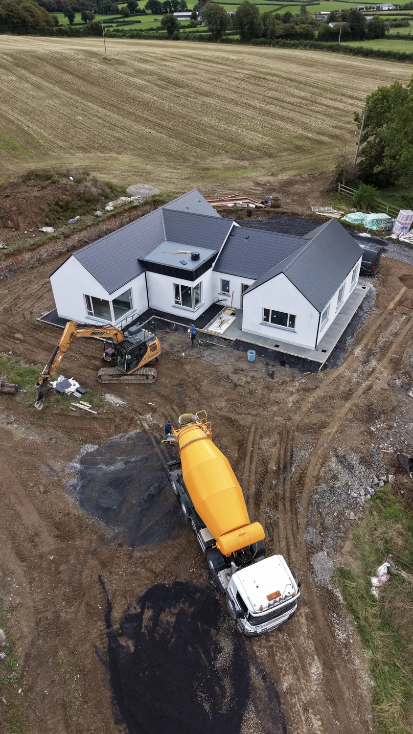 Aerial view of a new home surrounded by earthworks and access tracks