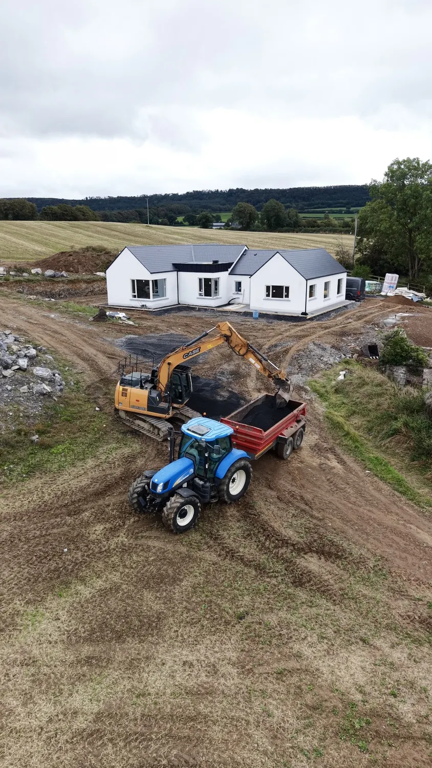 Aerial view of earthmoving machinery working around a new home