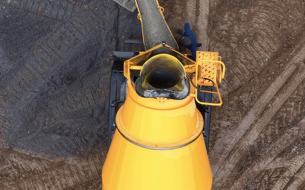 Precast wastewater tank being lowered into a trench for a drainage installation