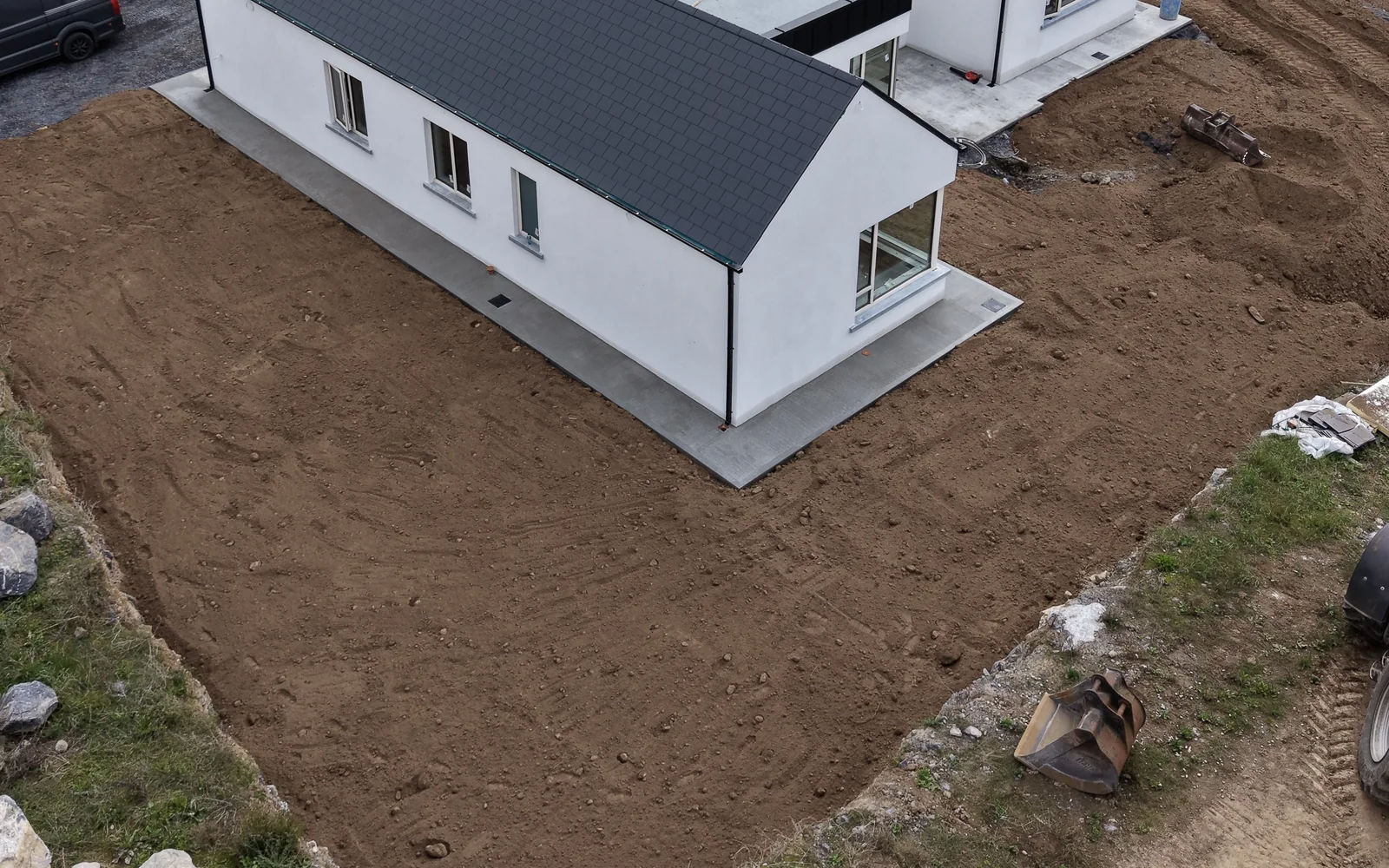 Aerial view of groundworks and graded earth around a newly built house in Carlow
