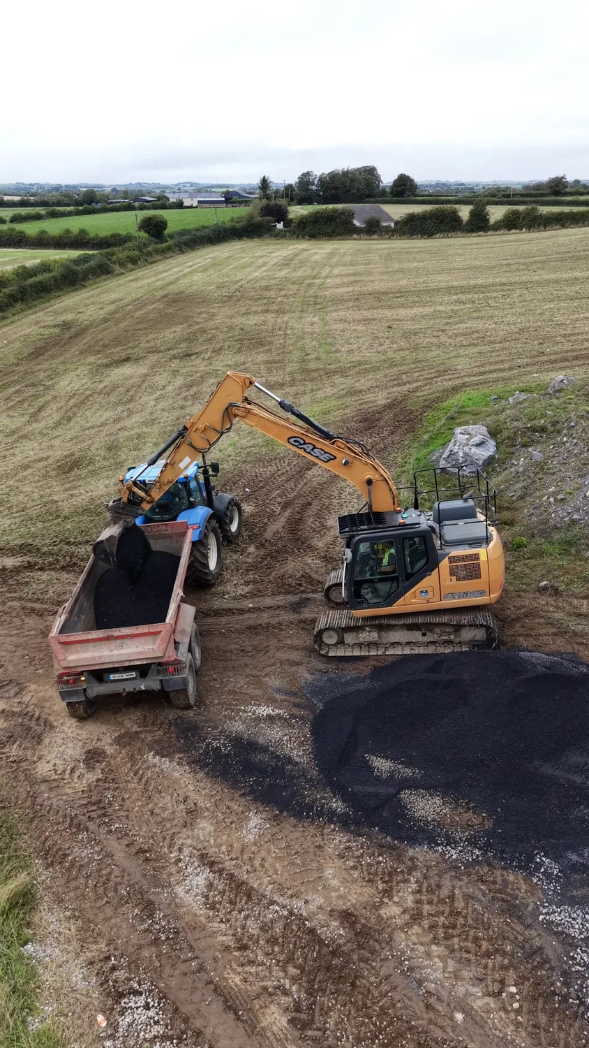 Aerial view of excavators and a tipper lorry on a prepared site