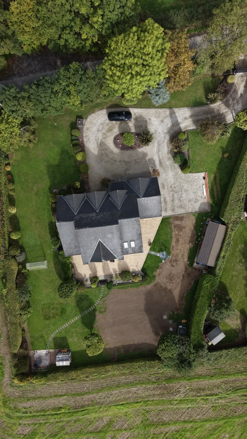 Aerial view of a freshly worked garden beside a rural home