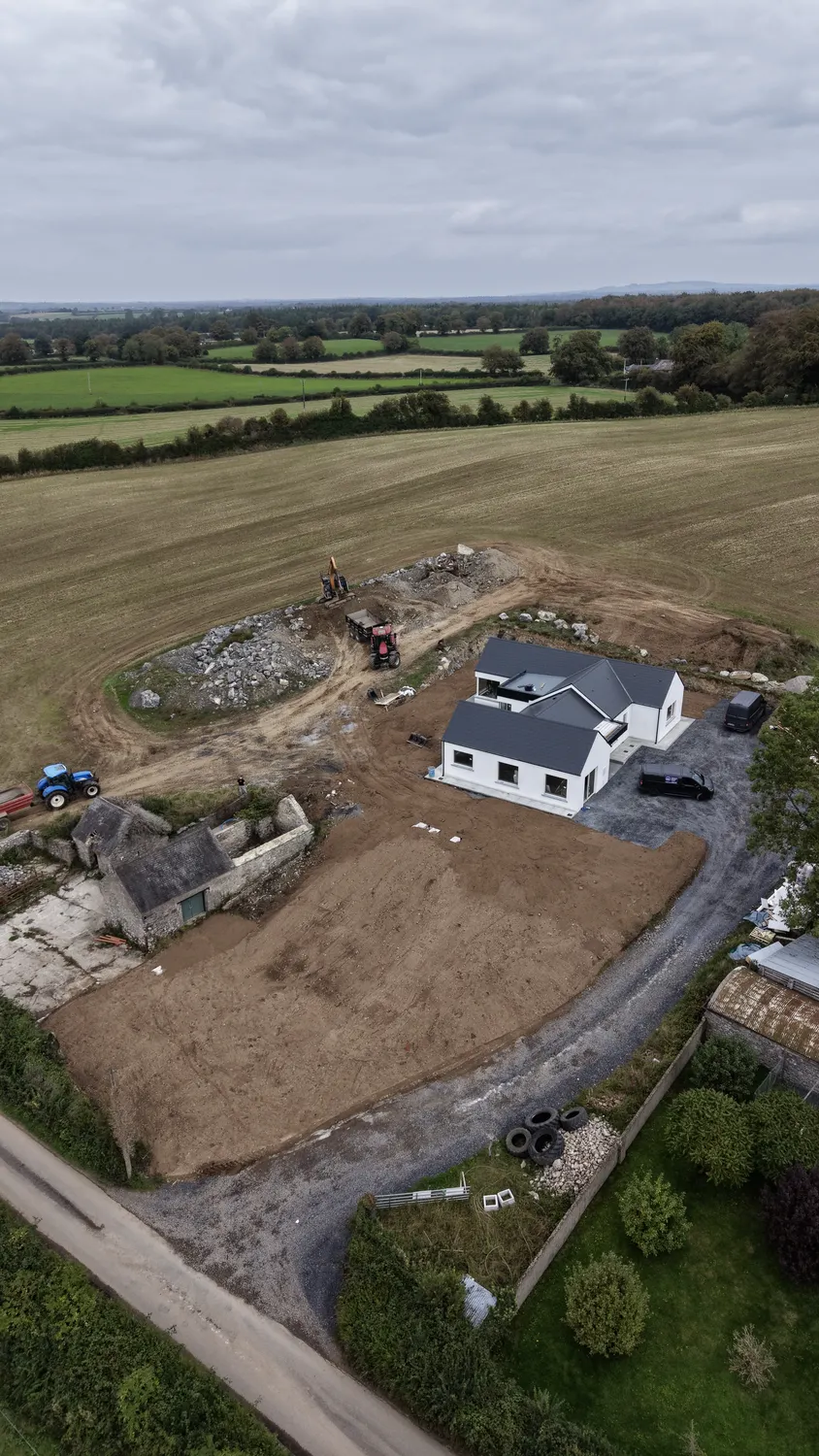 Elevated view of ground preparation around a new house in a rural field