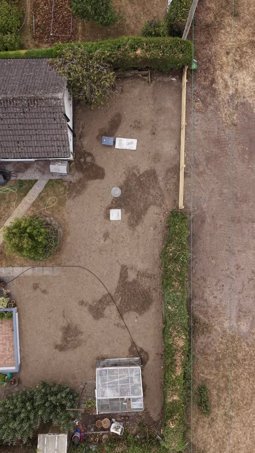 Elevated view of a cleared garden and neighbouring fields