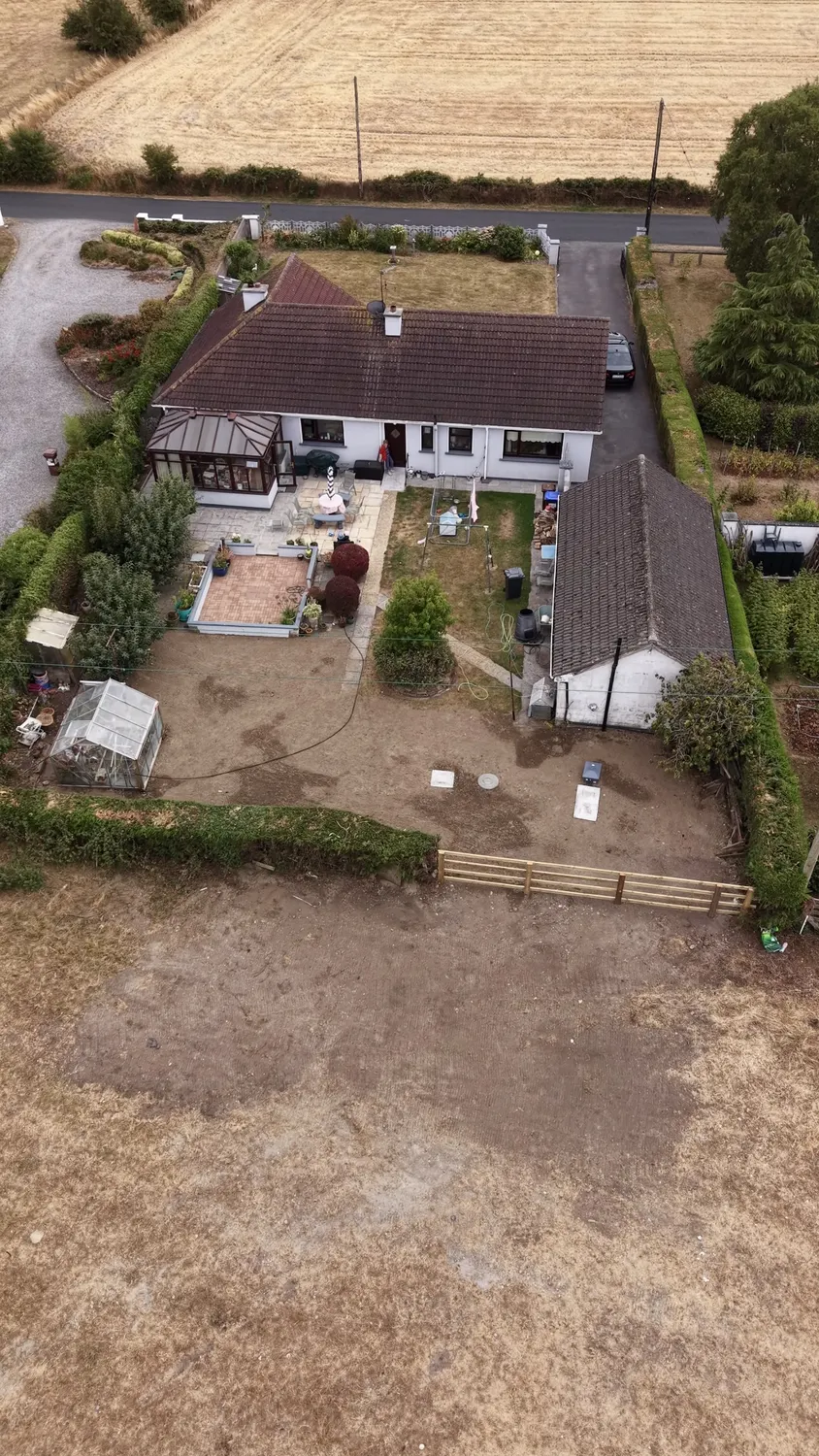 Aerial view of a house and newly prepared garden area