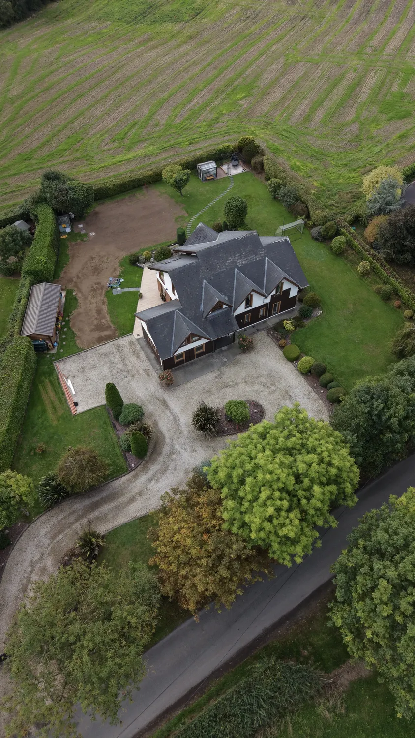 Overhead view of newly worked garden soil beside a house