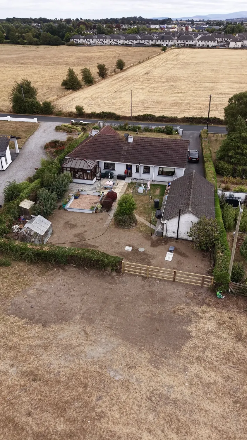 Aerial view of graded earth around a house and garden