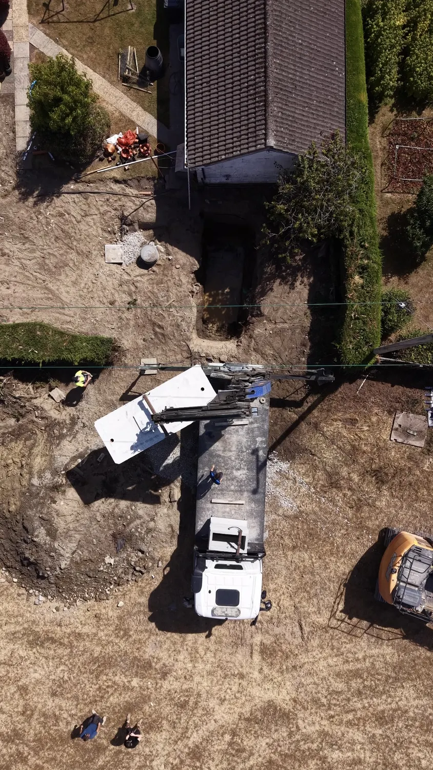 Aerial view of graded garden soil and an excavator