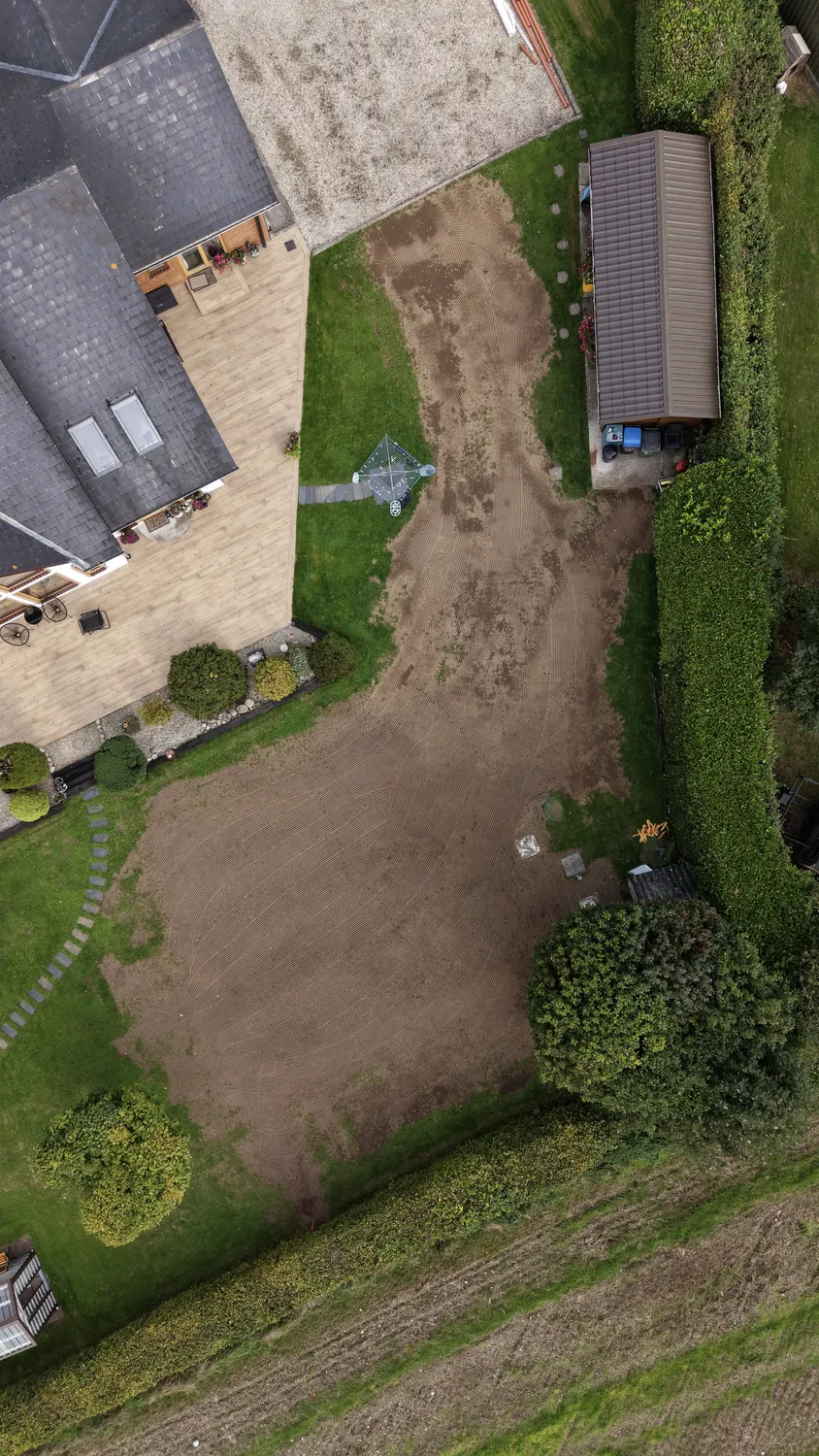 Top-down view of garden ground preparation near mature trees